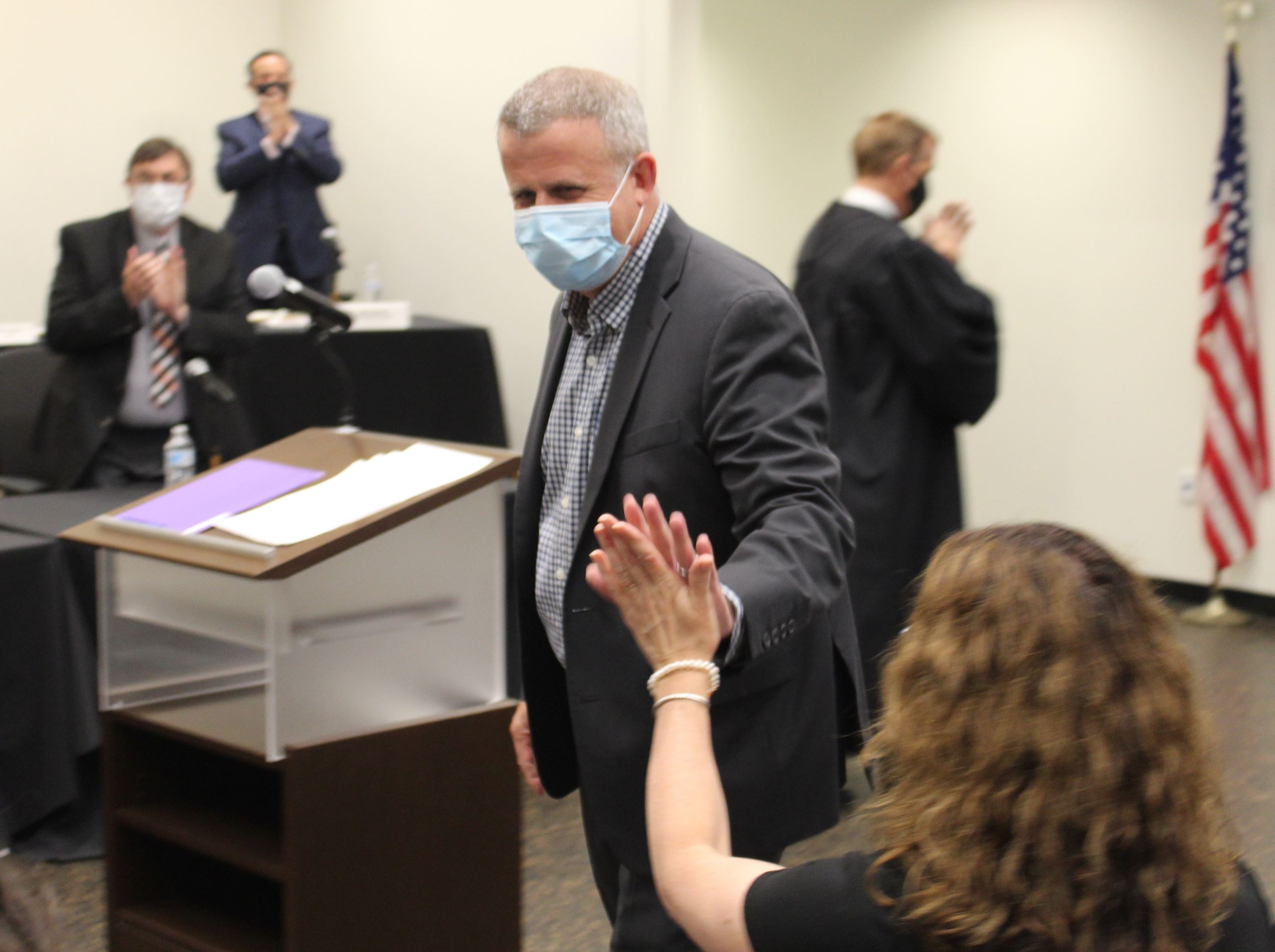 Mayor Cohen Barnes gives high fives to family members after taking the oath of office.