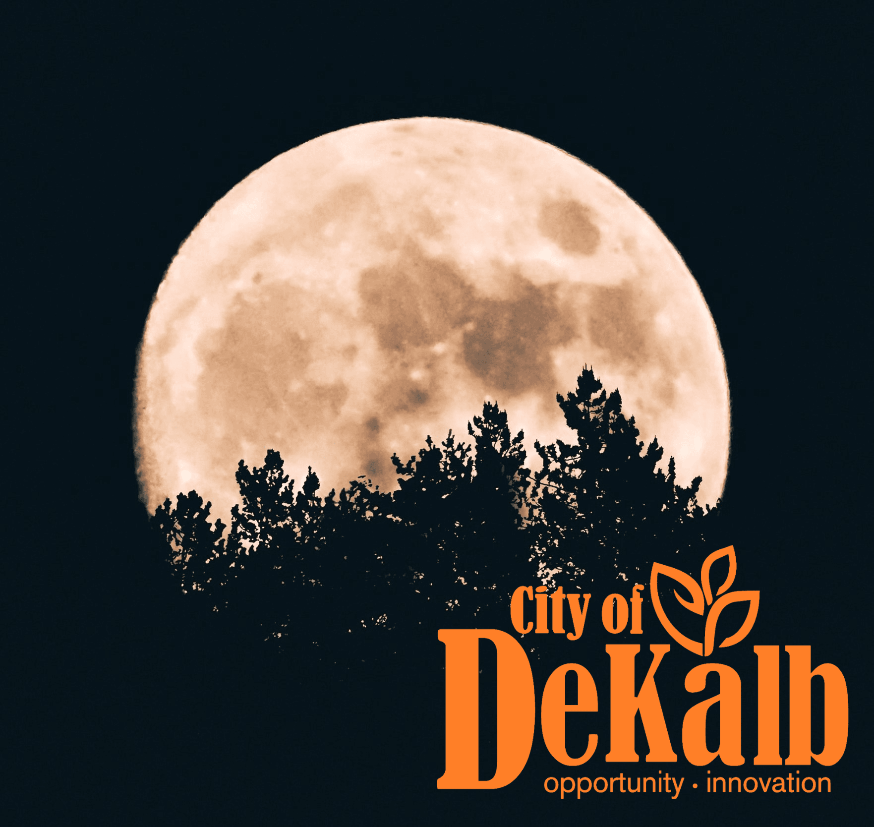 A full moon behind trees and the DeKalb logo
