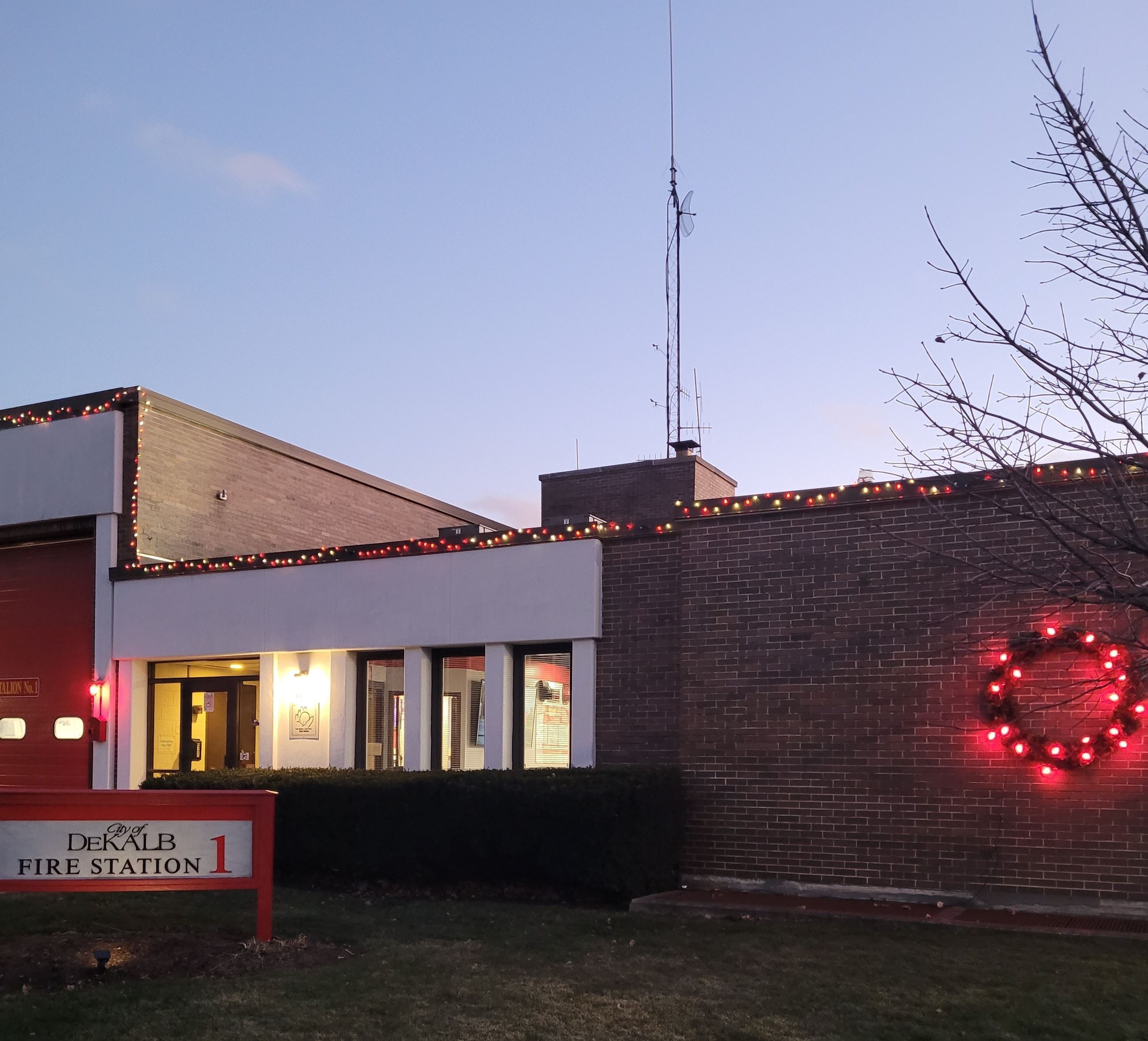 A wreath with red lights is hung on Fire Station One.