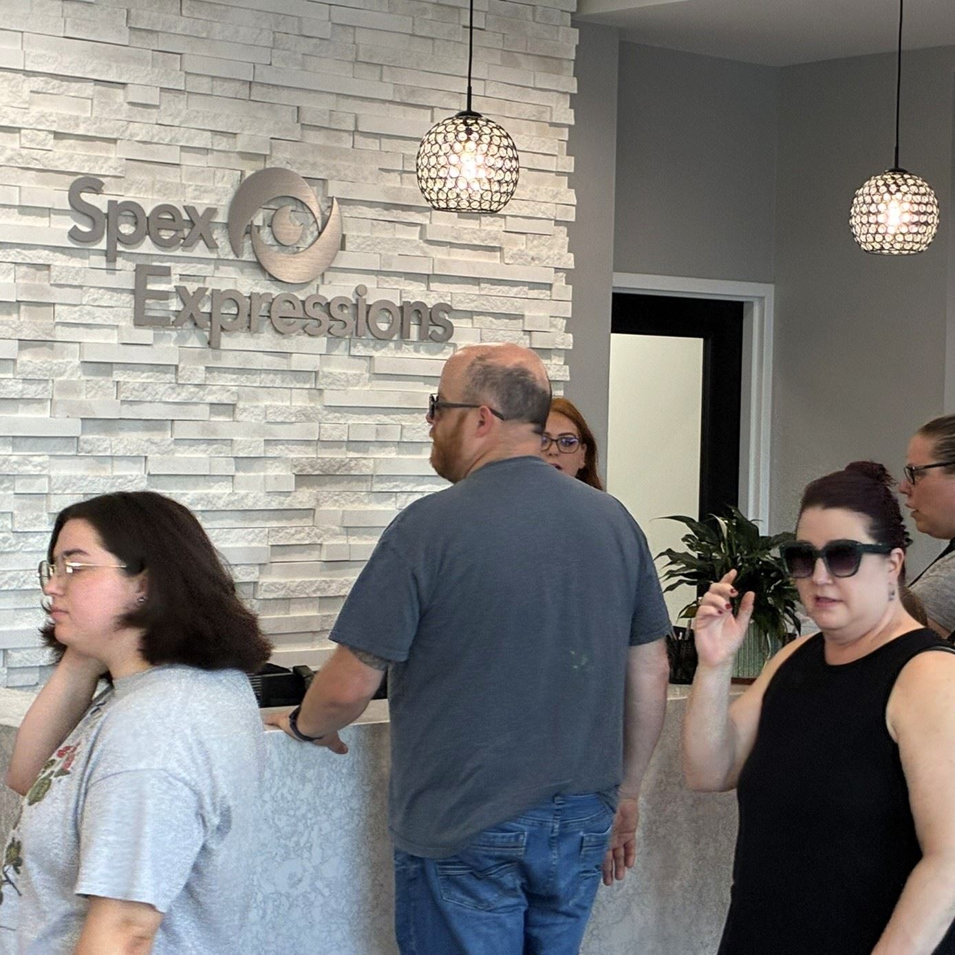 Customers in front of the counter at Spex Expressions