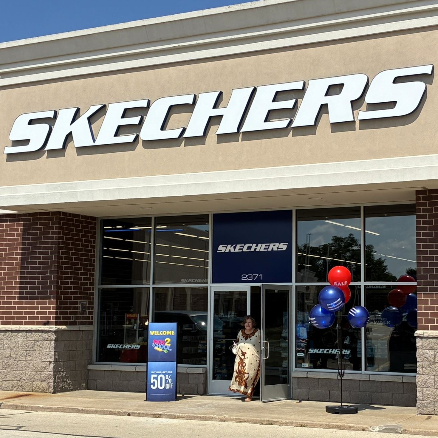 A customer walking out of the Sketchers store