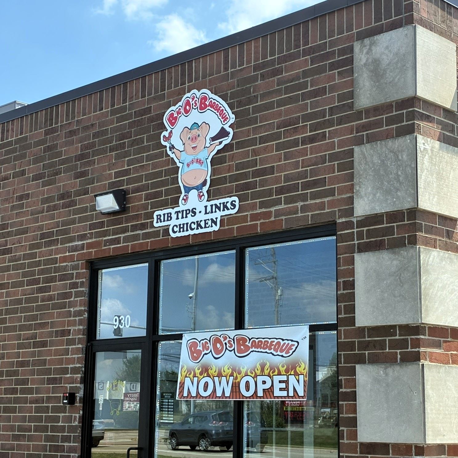 The front of Big O&#39s Barbecue with a grand opening banner