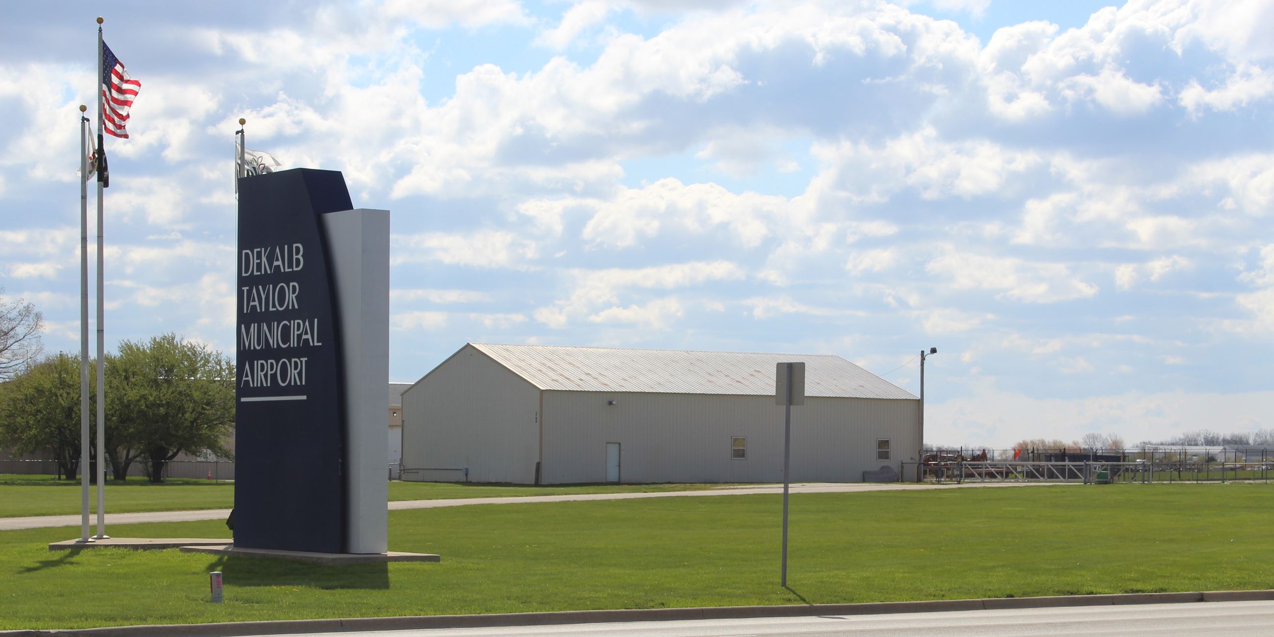 The DeKalb Taylor Municipal Airport sign and a hangar