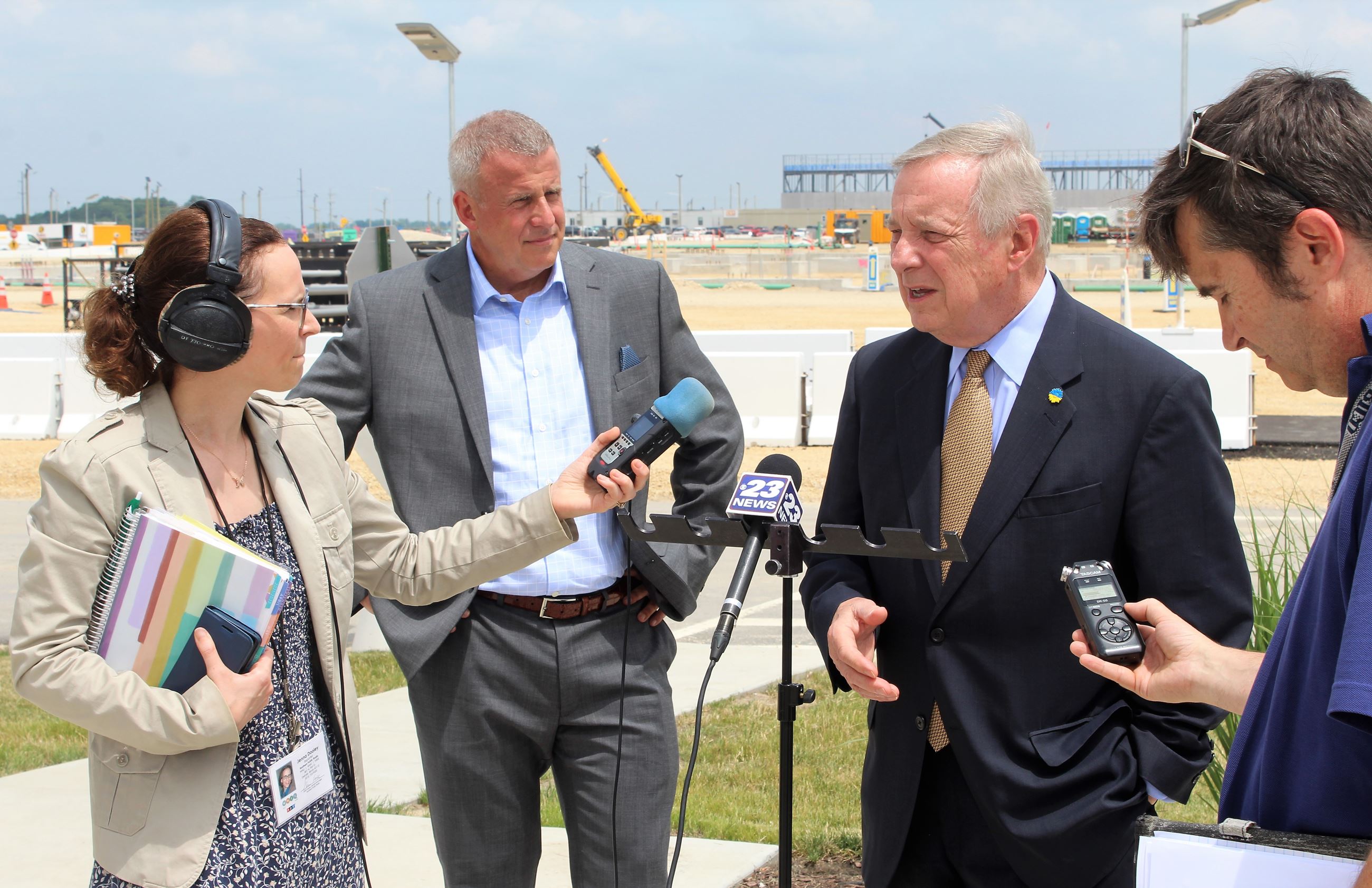 Senator Dick Durban and Mayor Cohen Barnes talk with reporters at Meta's DeKalb Data Center