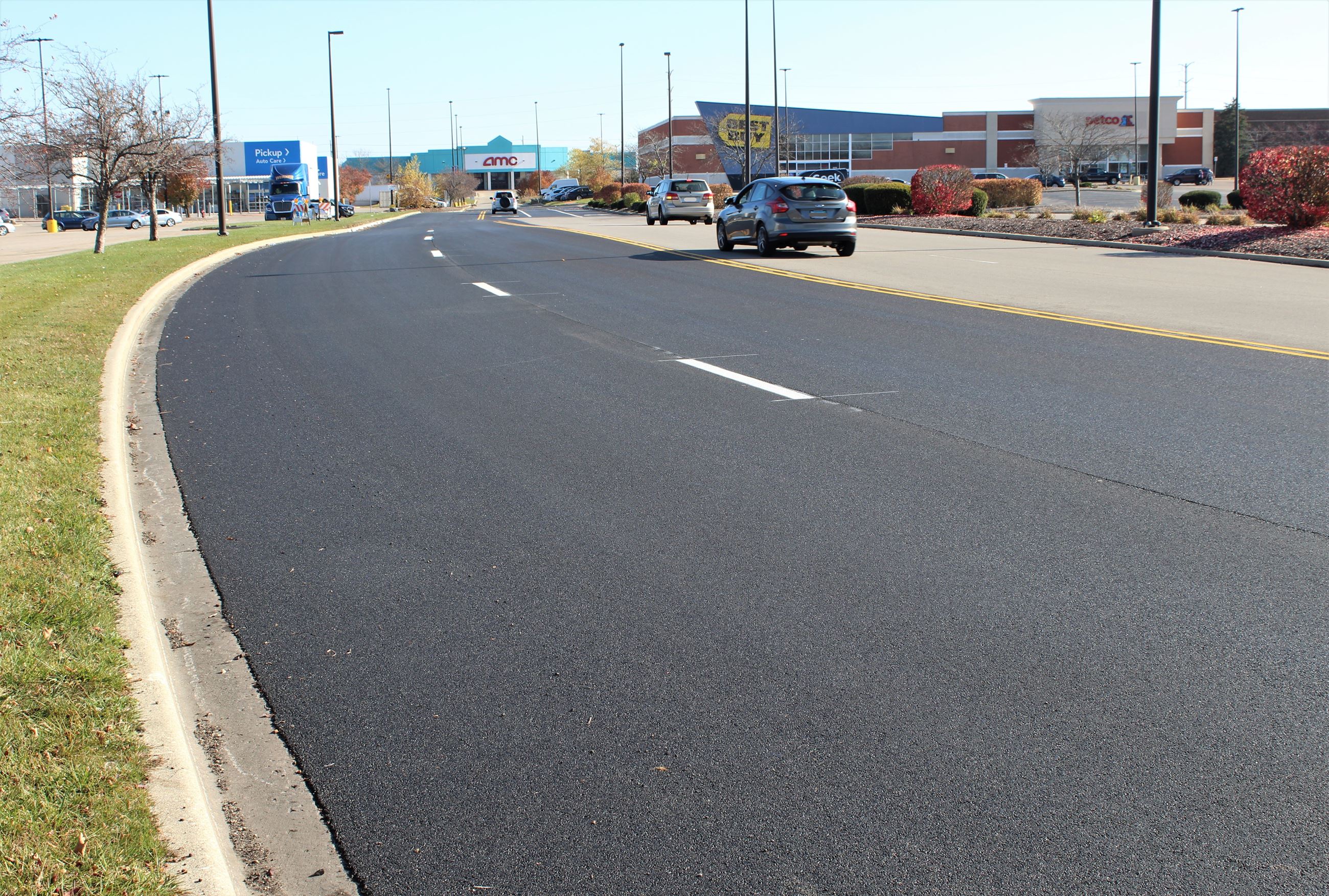 Cars travel down a freshly repaved road in the Market Square Shopping Center.